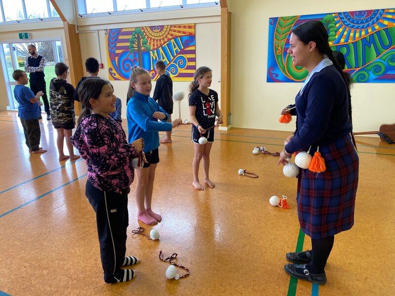 Photo of students learning poi